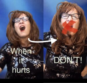 Four people singing outdoors in winter with songbooks.