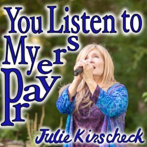 Four people singing outdoors in winter with songbooks.