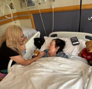 Four people singing outdoors in winter with songbooks.